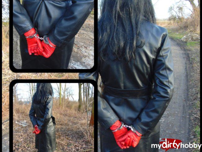 A small walk in a leather coat and with handcuffs