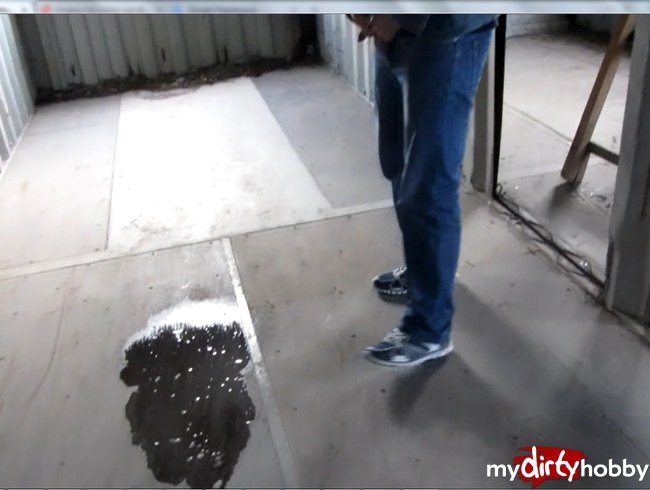 The guy pees in a puddle of urine